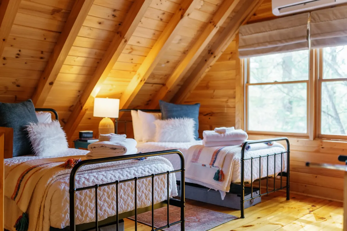 Loft bedroom with 32" Roku Smart TV, twin beds, and its own AC unit