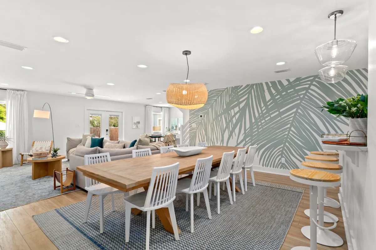 Open-concept kitchen, dining, and living room. Dining table comfortably seats 10 people.